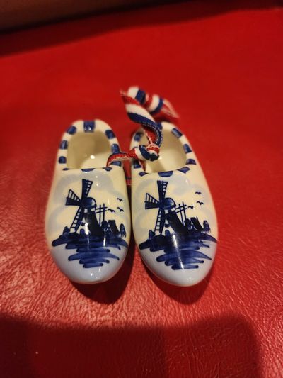 a pair of miniature Delft blue ceramic Dutch clogs a pair of miniature Delft blue ceramic Dutch clogs