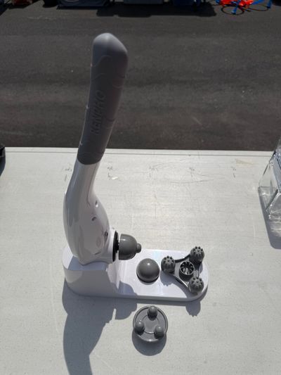 Cordless rechargeable handheld massager With several attachments and stand