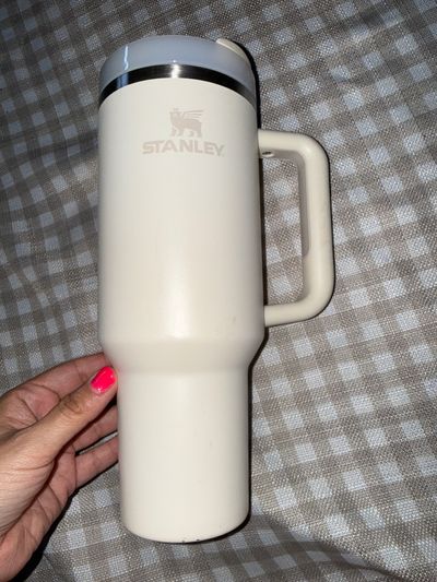 Stanley 40 oz tumbler with handle and lid in cream color  some marks