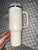 Stanley 40 oz tumbler with handle and lid in cream color  some marks