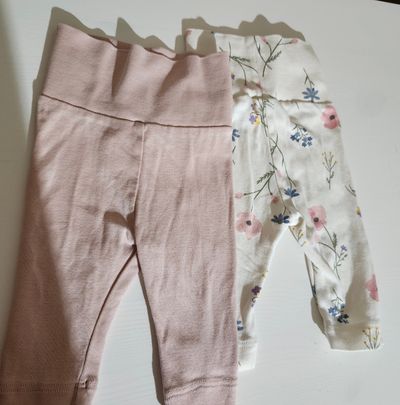 H&m foldover pants 2 pack pink and floral Marked nb but fits like 0-3. Both same size photo angle bad 0-3 Months