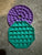 2 poppers 2 poppers. One round purple and one green octagon