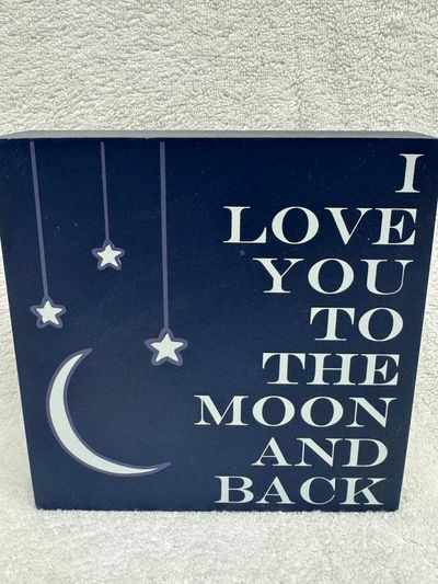 Home sign. Says I love you to the moon and back Home sign. Says I love you to the moon and back