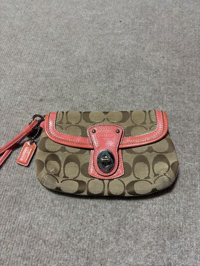 Coach Wristlet with salmon color trim. Back zip. EUC