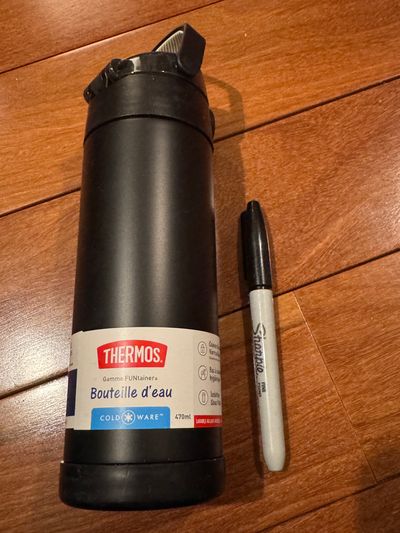 Brand new black thermos water bottle stays cold 12 Hours comes with a lock flips open and carrying handle