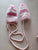 The children place pair of -knitted pink and white striped baby mittens. Infant (0-2 yrs)
