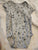 Carter bodysuit features a playful bears and penguins skiing, along wit 24 Months